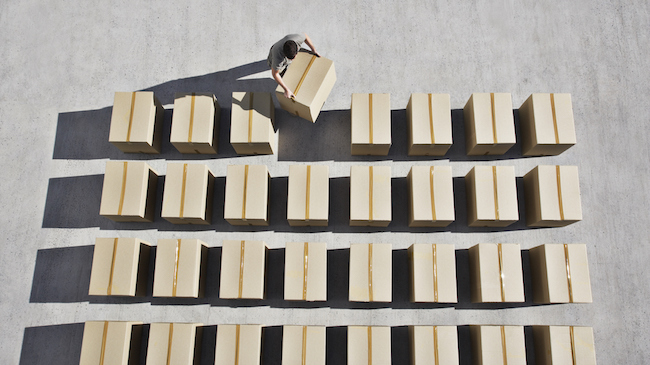 Man Aligning Cardboard Boxes